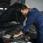 male-mechanic-working-auto-repair-shop-car